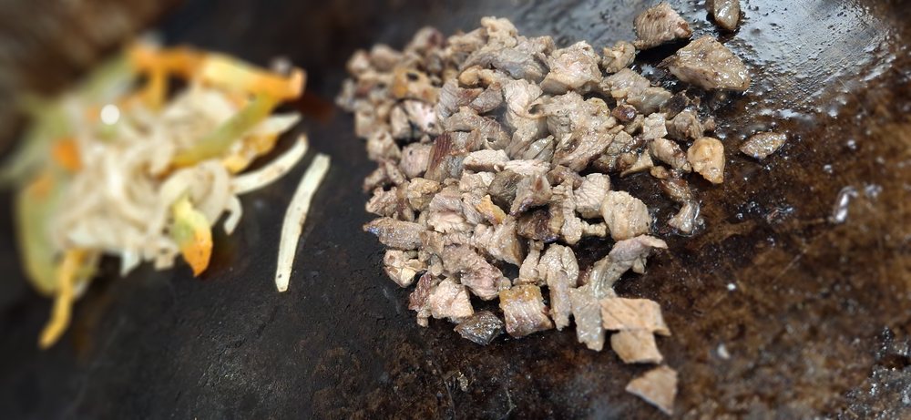 Steak and peppers on the griddle